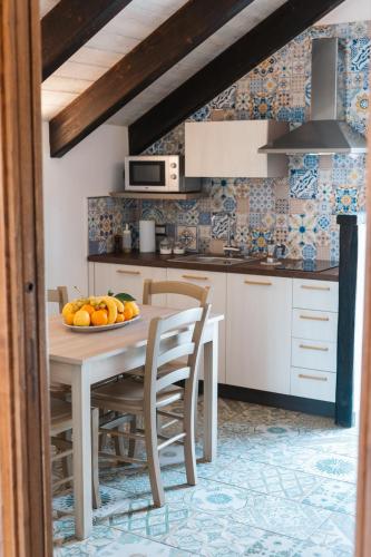 a kitchen with a table with a bowl of fruit on it at Il Casale del Contadino in Agerola