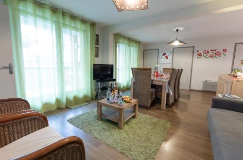 a living room with a couch and a table at Appartement Le Bois de Marie in Barèges