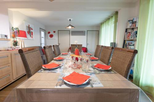 a dining room table with red napkins on it at Appartement Le Bois de Marie in Barèges