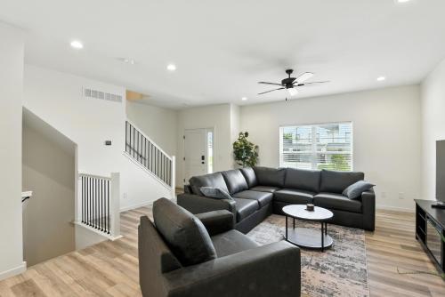 a living room with a couch and a table at Modern Townhome Retreat in Prime Location townhouse in Coralville