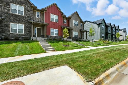a row of houses in a residential neighborhood at Modern Townhome Retreat in Prime Location townhouse in Coralville