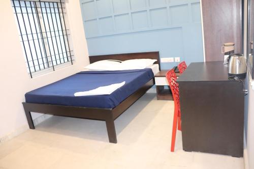 a bedroom with a bed and a table and a desk at Urban Nest in Salem