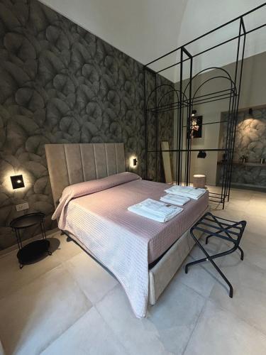 a bedroom with a bed and a stone wall at Donna Sofia in Torre Annunziata