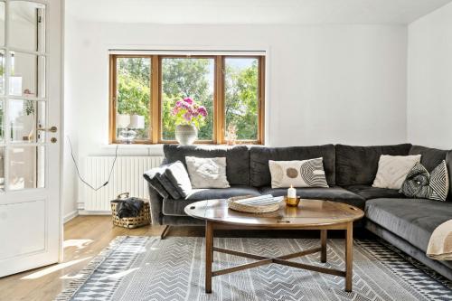 a living room with a couch and a table at Charming Holiday Home On The Island Of Fejø in Vejrø