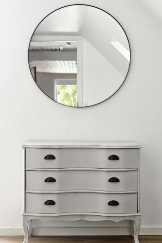 a white dresser with a mirror on top of it at Charming Holiday Home On The Island Of Fejø in Vejrø