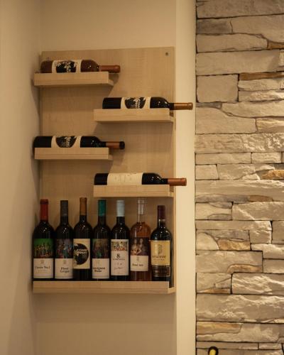 a bunch of bottles of wine on a wall at Guest House Panorama Aqualux with Free Parking in Novi Sad