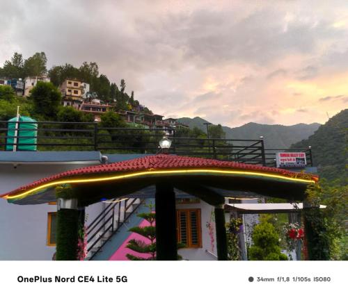 a large surfboard on top of a building at Enjoy Nature at Yamuna Valley Stay in Kandi