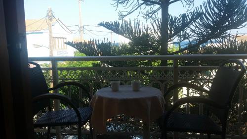 a table on a balcony with two candles on it at Marialena Pension in Iraion