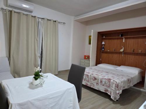 a hotel room with two beds and two tables at Bellavista Monolocale in Foligno