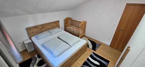 a bedroom with a bed with a wooden headboard at Apartment Residence House in Bihać