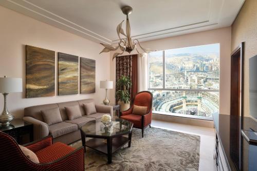 a living room with a couch and a table at Makkah Clock Royal Tower, A Fairmont Hotel in Makkah