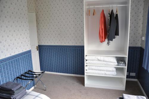 a bathroom with a closet with towels in it at Eaglesfield House Guest Apartment in Donaghey