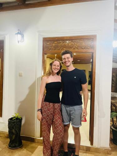 a man and a woman standing in front of a door at Udawalawa Eco Lodge in Udawalawe