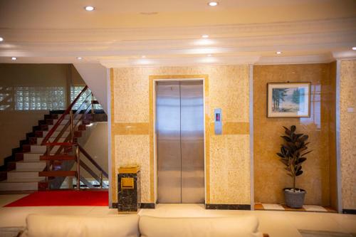 a elevator in a building with a staircase at Tiffany Diamond Hotels Ltd - Indira Gandhi street in Dar es Salaam