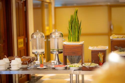 a table with food on it with a buffet at Tiffany Diamond Hotels Ltd - Indira Gandhi street in Dar es Salaam