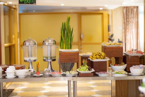 a buffet of food on a table in a room at Tiffany Diamond Hotels Ltd - Indira Gandhi street in Dar es Salaam