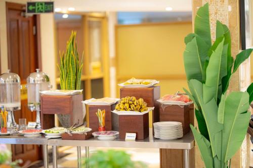 a buffet of food on a table with bananas on it at Tiffany Diamond Hotels Ltd - Indira Gandhi street in Dar es Salaam