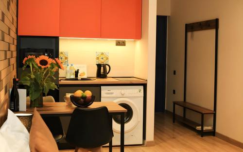 a kitchen with a table and a washing machine at Rooms Apart Hotel by RED in Yerevan