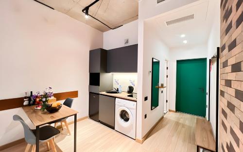 a kitchen with a washing machine and a table at Rooms Apart Hotel by RED in Yerevan