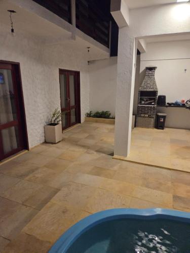 a room with a swimming pool and a fireplace at Aurora Beach in Trairi