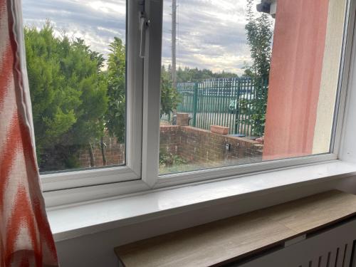 a window sill with a view of a building at 4-Bed Barnwell Retreat- Sleeps 9 Garden & Parking in Stevenage