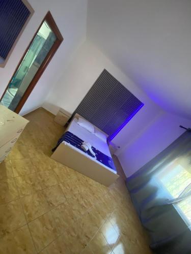 an empty room with a bed and a box at Jaupaj Rent House in Vlorë