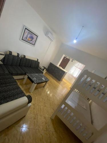 a living room with a couch and a table at Jaupaj Rent House in Vlorë
