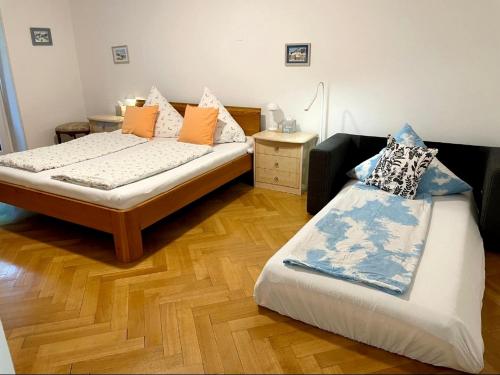 a bedroom with two beds and a couch in it at Art studio 64 in Basel