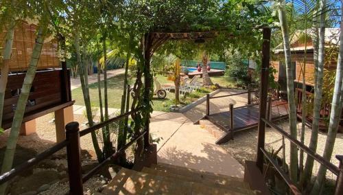 a gate to a park with a bench and trees at Charming House in Albion with Shared Pool in Albion