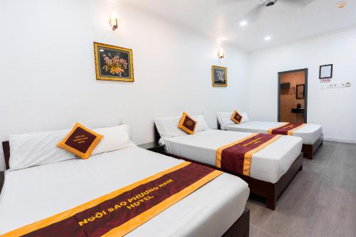 three beds in a room with white walls at Townhouse Oak Southern Star Hotel Quang Trung Industrial Zone District 12 in Ho Chi Minh City