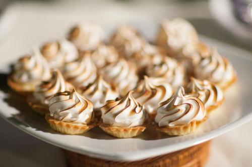 a plate of cupcakes with chocolate and white frosting at The Inbal Jerusalem in Jerusalem