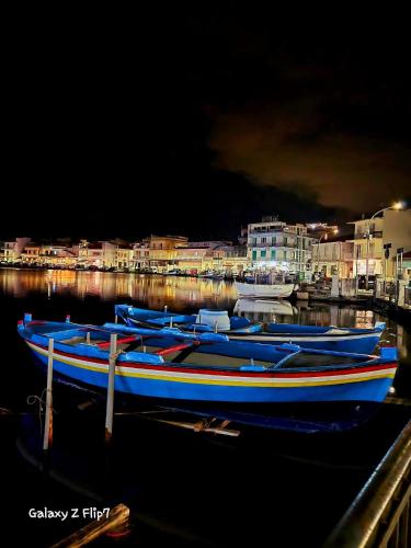 a group of boats docked in a harbor at night at Villa Fiori e Sapori in Messina