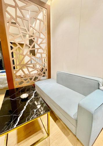a living room with a couch and a table at CotySoulStay in Ghaziabad
