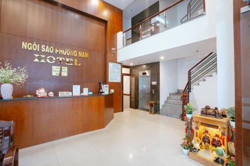 a lobby of a hotel with a staircase at Townhouse Oak Southern Star Hotel Quang Trung Industrial Zone District 12 in Ho Chi Minh City