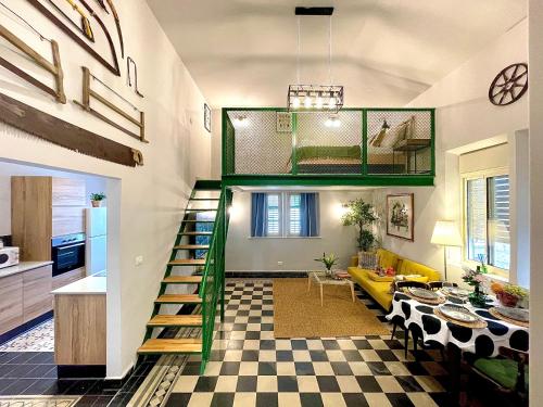 a living room with a green staircase in a house at Authentic apartments with jacuzzi and Two-level central Haifa in Haifa