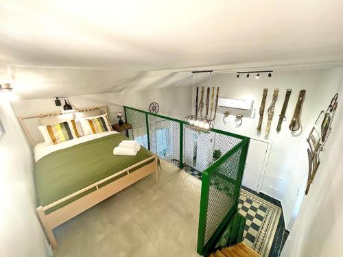 a bedroom with a green bed and a balcony at Authentic apartments with jacuzzi and Two-level central Haifa in Haifa