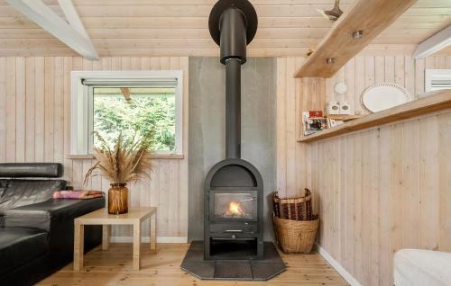 a living room with a wood stove in a room at Three-Bedroom Holiday Home In Hovborg in Hovborg