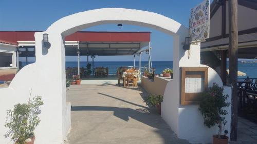 an entrance to a restaurant with a view of the ocean at Marialena Pension in Iraion