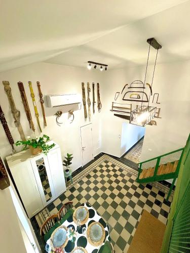 a kitchen with a checkered floor and a room with baseball equipment at Authentic apartments with jacuzzi and Two-level central Haifa in Haifa