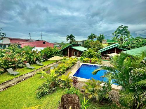 an aerial view of a resort with a swimming pool at Cabañas Litos #3 in Fortuna