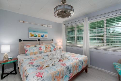 a bedroom with a bed and a window at Tropic Terrace Suite #29 - Beachfront Resort in St Pete Beach