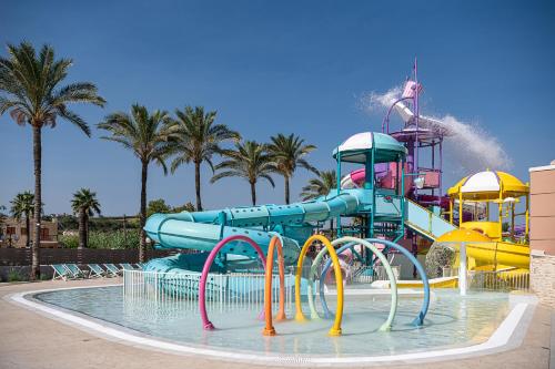 a water park with a water slide at Caldera Beach in Plataniás