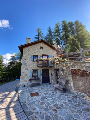 a large stone building with a balcony on it at Chalet Charm by Original Galli in Livigno