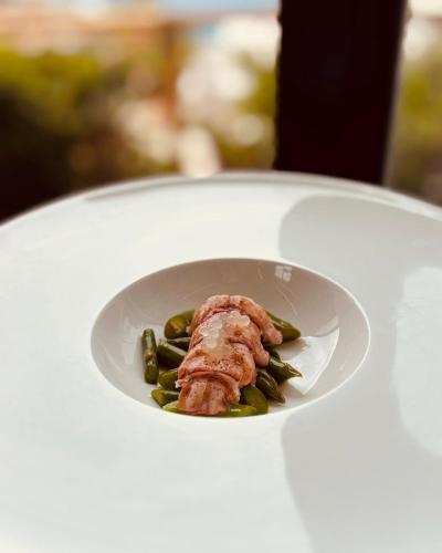 a plate of food with meat and green beans at Borgo Rosso di Sera - Resort Country Chic in San Lucido