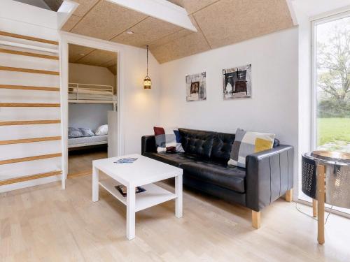 a living room with a couch and a table at 6 person holiday home in Løkken in Løkken