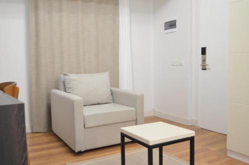 a living room with a chair and a table at niXie Hotel Bodrum in Bodrum City