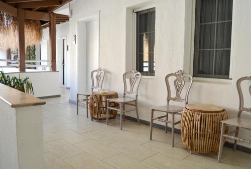three chairs and a table in a room at niXie Hotel Bodrum in Bodrum City