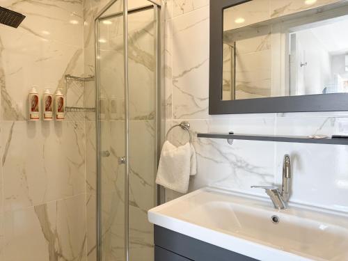 a bathroom with a sink and a glass shower at niXie Hotel Bodrum in Bodrum City