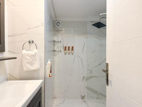 a white bathroom with a shower and a sink at niXie Hotel Bodrum in Bodrum City