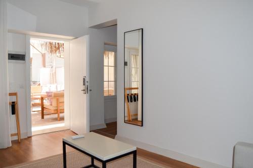 a living room with a table and a mirror at niXie Hotel Bodrum in Bodrum City